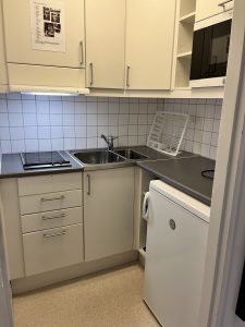 Kök med vask, spishäll och köksinredning.
